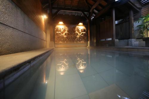 a swimming pool with lights in a building at Shan-Yue Hotspring Hotel in Taipei