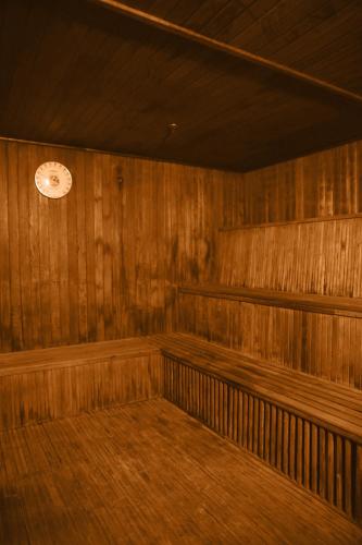 a wooden room with a clock on the wall at Shan-Yue Hotspring Hotel in Taipei