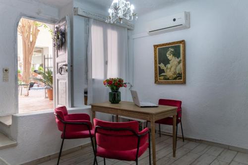 a room with a table with chairs and a laptop at Porto Maltese Boutique Estate in Agios Nikolaos