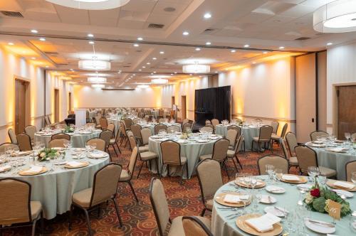 a banquet hall with tables and chairs and a podium at Toftrees Golf Resort in State College