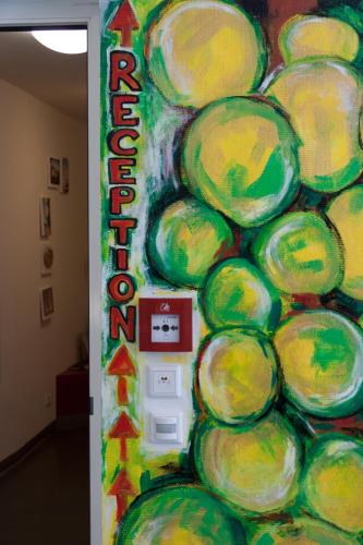 a colorful wall with a sign that reads recycling at Babelfish Hostel in Würzburg