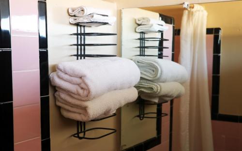 a towel rack with towels on it in a bathroom at Royal Inn - North Augusta - Home Of The Masters - Augusta Downtown in Beech Island