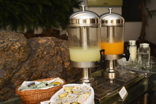 a blender sitting on a table with an orange juice at Hotel Village Icaraí in Niterói