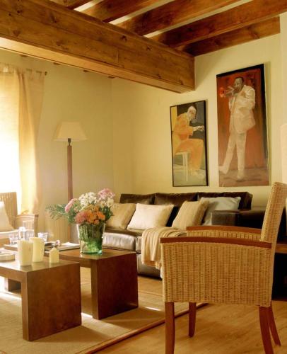 a living room with a couch and a table at Casa Granero in Rascafría