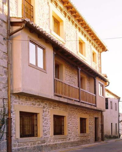 a building with a balcony on the side of it at Casa Granero in Rascafría