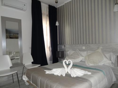a bedroom with a bed with a white flower on it at Hostal Main Street Madrid in Madrid