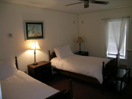 A bed or beds in a room at Emilyville Inn