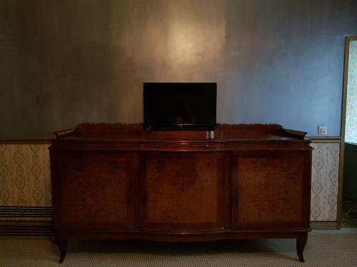 a wooden desk with a laptop on top of it at NF Palace Old City Bucharest in Bucharest
