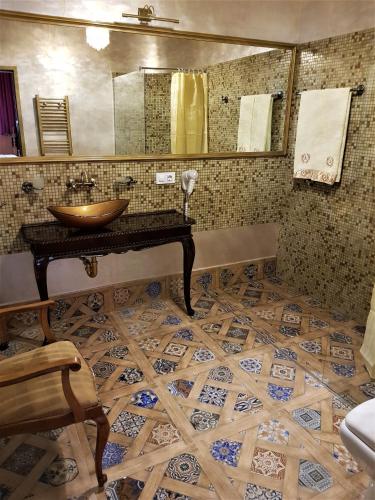 a bathroom with a sink and a mirror at NF Palace Old City Bucharest in Bucharest