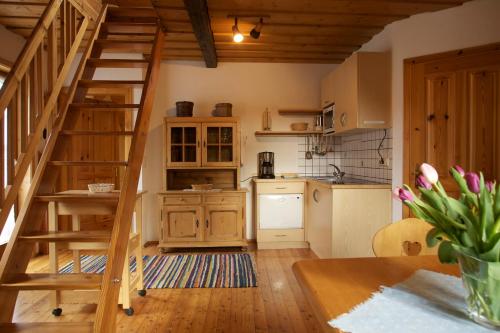 a kitchen with a wooden staircase in a room at Holzblockhäuser Fam. Schabus in Hermagor