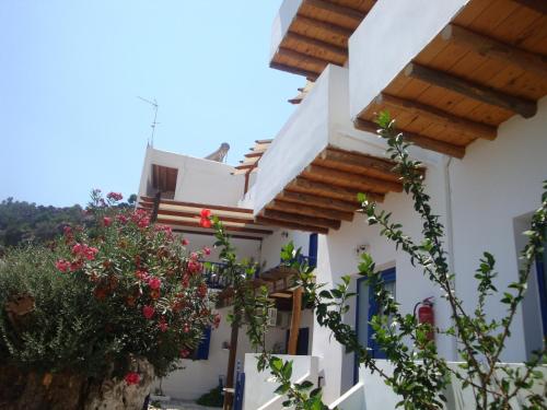 a house with white walls and wooden beams at Villa Niki in Loutro