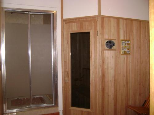 a bathroom with a shower and a glass door at Aldea Bonita in Villa La Angostura