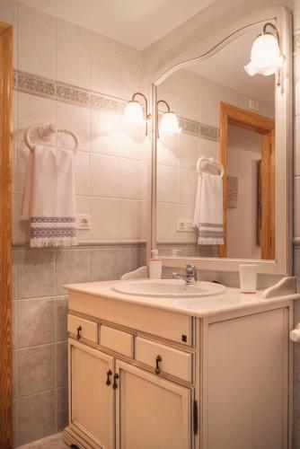 a bathroom with a sink and a mirror at Avinguda Mare Nostrum, 101 in Moncófar