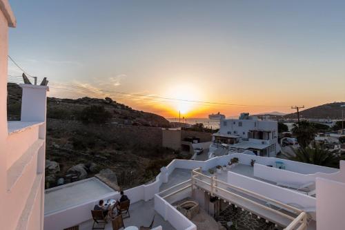 a sunset seen from the balcony of a building at Pension Alexandra Mykonos port in Mikonos