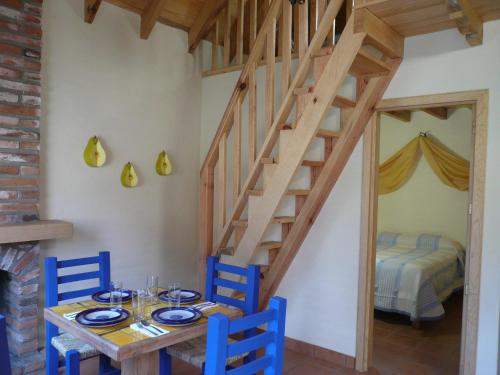 a dining room with a table and blue chairs at Cabañas Sierra Mazamitla in Mazamitla