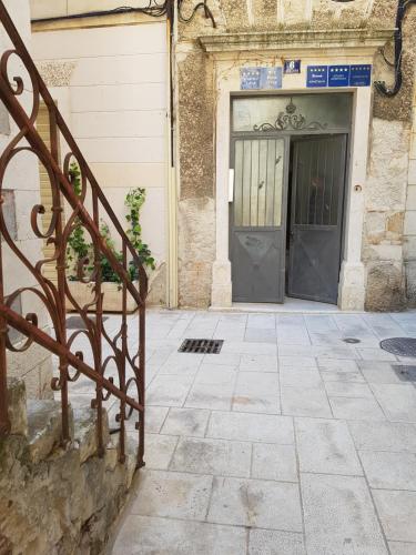 a metal staircase in front of a building with a door at Riva Palace in Split