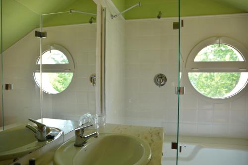 a bathroom with a sink and a glass shower at El Habana Llanes in Llanes