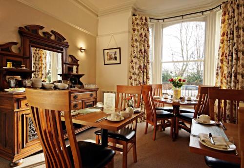 a kitchen and dining room with a table and chairs at Bronte Guest House in York