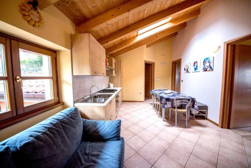 a kitchen with a couch and a table in a room at Sweet Spot in Riva del Garda