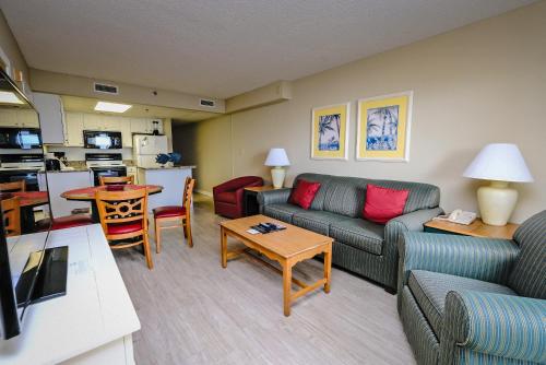 a living room with a couch and a table at Litchfield Beach & Golf Resort in Pawleys Island