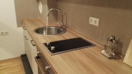 a kitchen with a sink in a wooden counter top at Apartment Abia in Bihać