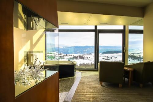 a living room with a view of a ski slope at Sparkling Hill Resort and Spa - Adults-Only Resort in Vernon