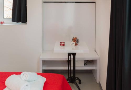 a room with a bed and a table with towels at PLR Luxury Rooms in Split