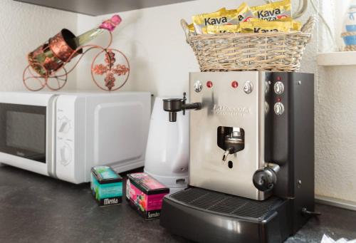 a coffee maker is sitting next to a microwave at PLR Luxury Rooms in Split