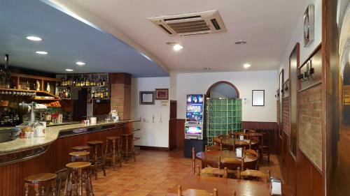 a restaurant with tables and chairs and a bar at Hotel San Jacobo in Santiago de Compostela