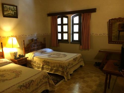 Postel nebo postele na pokoji v ubytování Posada Coatepec