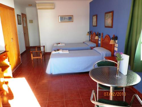 a bedroom with a bed and a table in a room at Casa Francisco el de Siempre in El Palmar