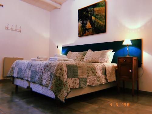 a bedroom with a bed with a quilt on it at Molino la Tebaida in San Martín