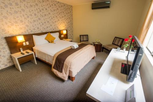 מיטה או מיטות בחדר ב-Palmetto Hotel Business La Perla