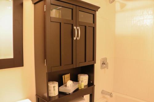a bathroom with a cabinet with toiletries on it at The Waterfront Suites and Marina in Nanaimo