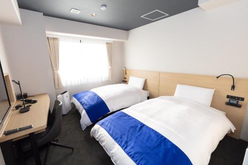 Postel nebo postele na pokoji v ubytování Ariston Hotel Kyoto Jujo