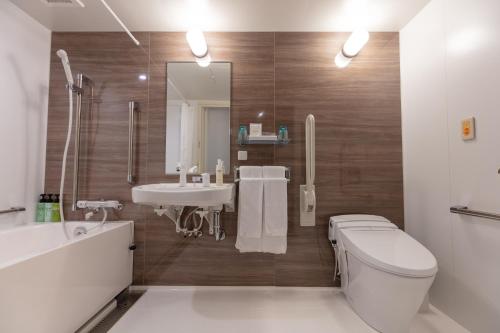 a bathroom with a toilet and a sink at Ariston Hotel Kyoto Jujo in Kyoto