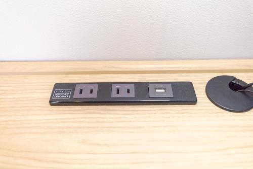 a mouse and a scale on a wooden table at Ariston Hotel Kyoto Jujo in Kyoto