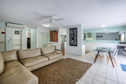 a living room with a couch and a table at Sunseeker Holiday Apartments in Sunshine Beach