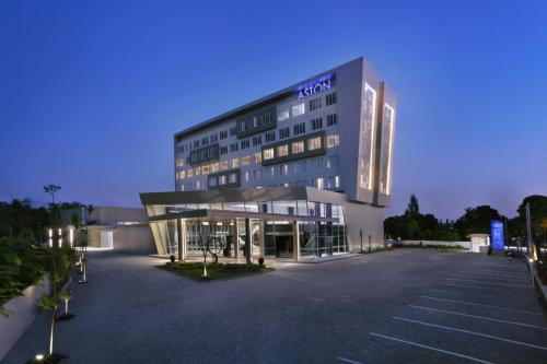 a building with a parking lot in front of it at ASTON Banyuwangi Hotel and Conference Center in Banyuwangi