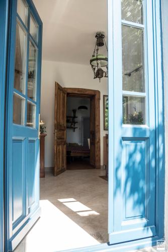 an open doorway to a room with a blue door at Liget Vendégház in Révfülöp