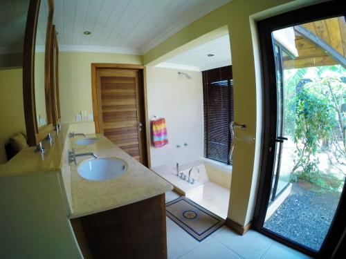 a bathroom with a sink and a shower at Villa Dodo in Pereybere