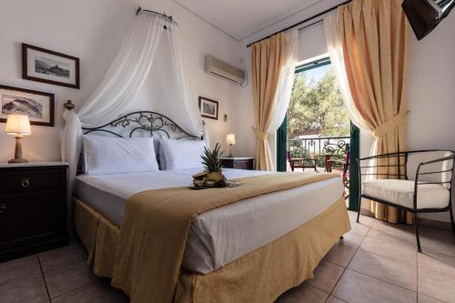 a bedroom with a large bed and a chair at Dionysos Hotel in Skala