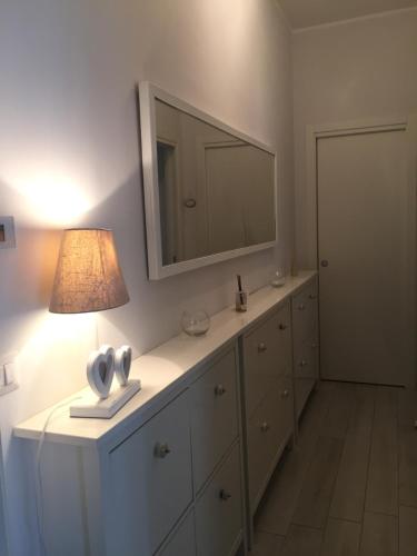 a bathroom with a vanity with a mirror and a lamp at Medeum in Modugno
