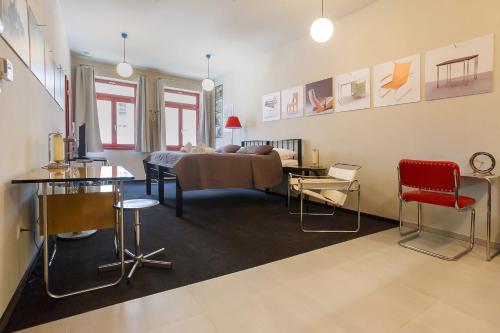 a living room with a bed and a table and chairs at Hotel & Depandance Kopacka in Lanškroun