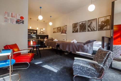 a living room with chairs and a dining room at Hotel & Depandance Kopacka in Lanškroun