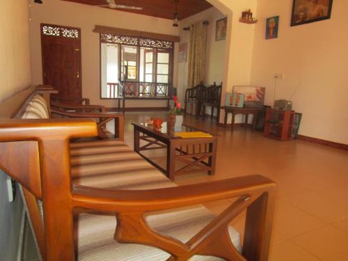 a living room with couches and tables in a room at Green Herbal Ayurvedic Eco-Lodge in Galle