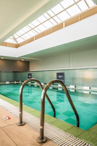 a swimming pool with two metal hand rails in it at Executive Residency by Best Western Nairobi in Nairobi