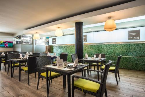 a restaurant with tables and chairs in a room at Executive Residency by Best Western Nairobi in Nairobi