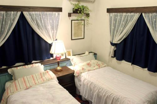 Ένα ή περισσότερα κρεβάτια σε δωμάτιο στο Okinawan. Sweet Home. T-8
