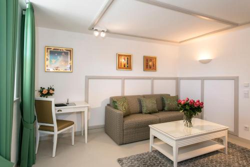 a living room with a couch and a table at Chiemsee Suiten in Übersee